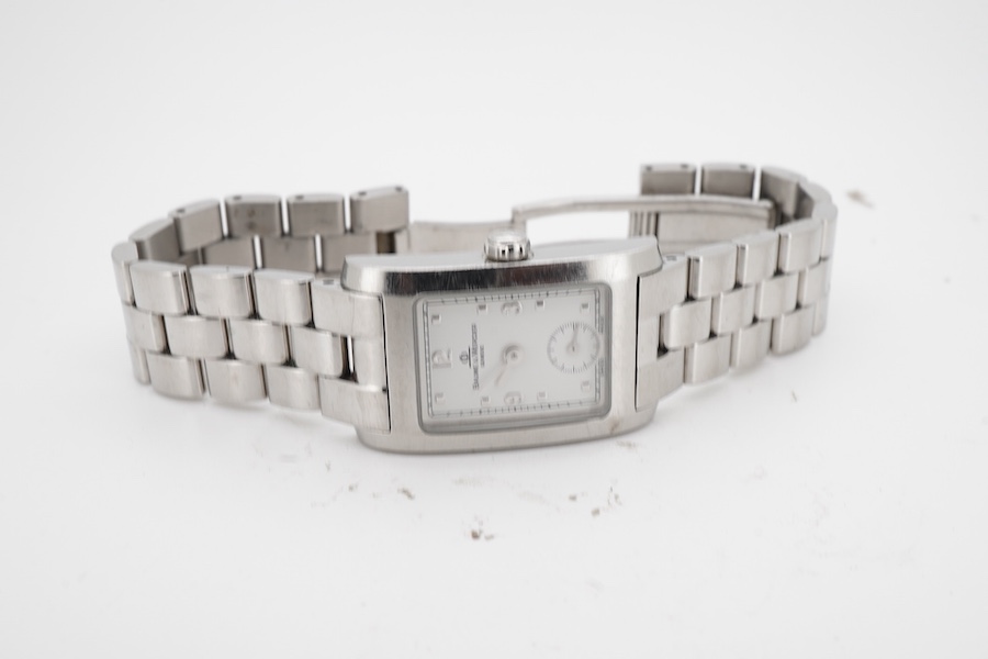 A lady's late 1990's stainless steel Baume & Mercier quartz wrist watch, with white rectangular dial and subsidiary seconds, case diameter 20mm, with guarantee card and booklet.